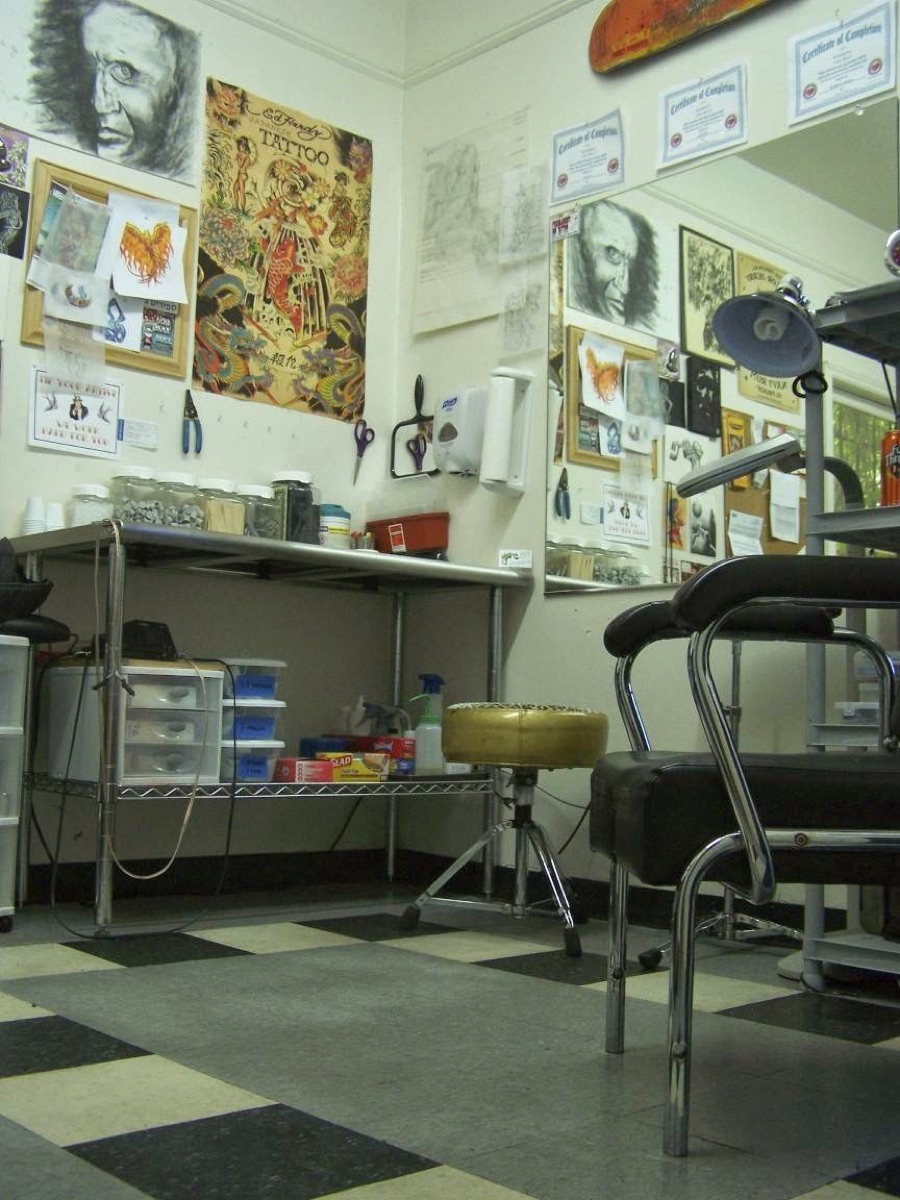 Tattoo station and flash art inside Absolution Ink Tattoo in Scottdale, GA